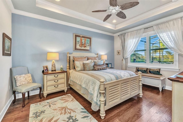 bedroom with a tray ceiling, crown molding, and dark wood-type flooring