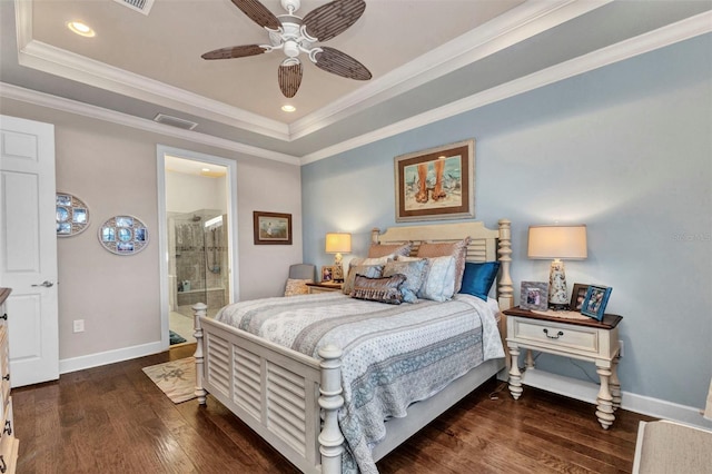 bedroom featuring wood finished floors, visible vents, baseboards, crown molding, and a raised ceiling