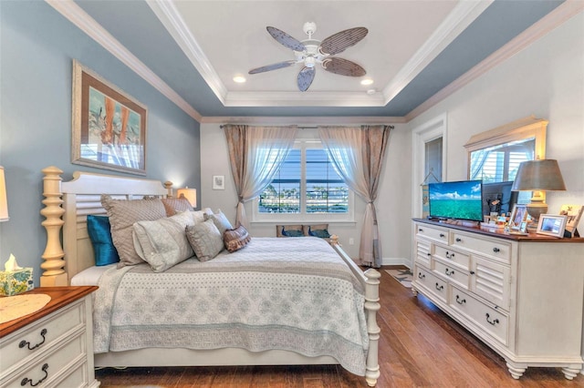 bedroom featuring ceiling fan, ornamental molding, recessed lighting, wood finished floors, and a raised ceiling