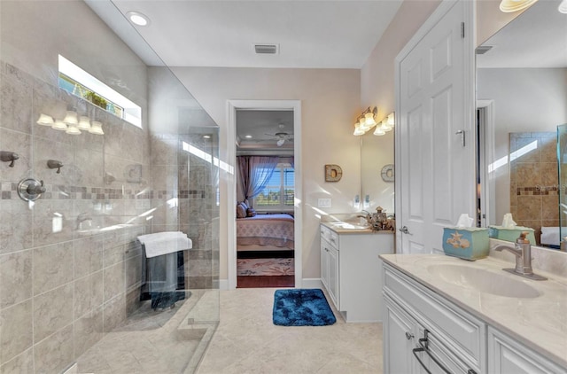 ensuite bathroom with visible vents, two vanities, ensuite bathroom, a sink, and a tile shower