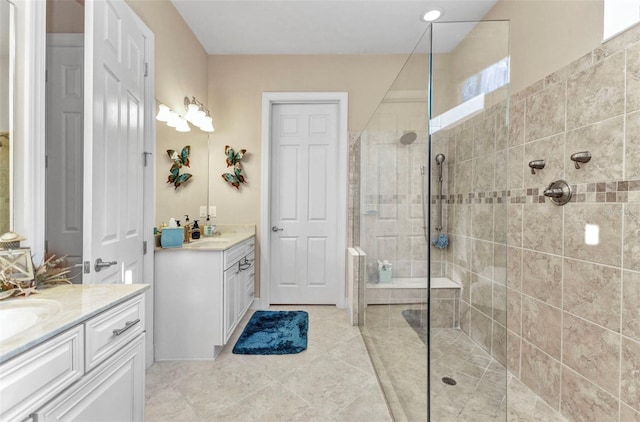 bathroom with a sink, two vanities, a shower stall, and tile patterned flooring