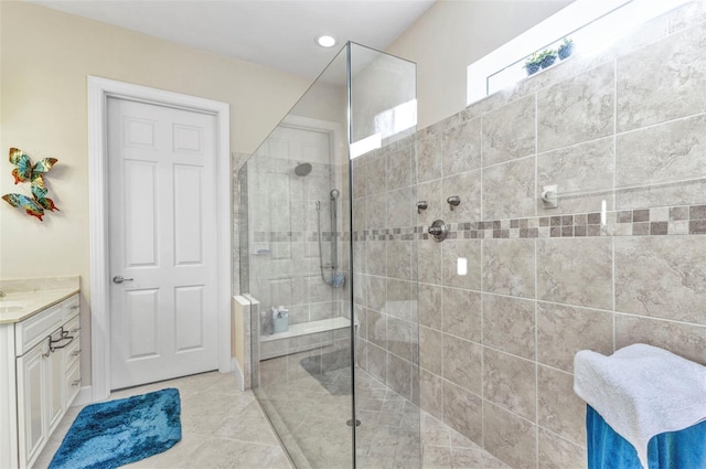 bathroom with vanity, tile patterned floors, and tiled shower