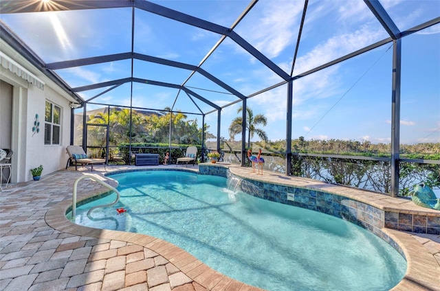 pool with glass enclosure, a patio, and a water view