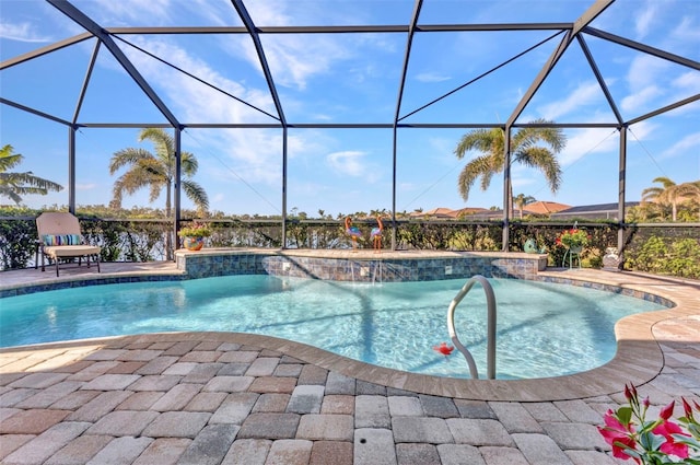 outdoor pool featuring glass enclosure and a patio area