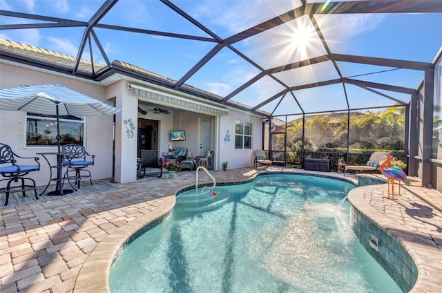 pool with a lanai, a patio area, and ceiling fan