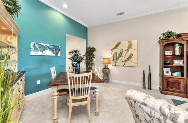 dining space featuring light tile patterned flooring, visible vents, crown molding, and baseboards