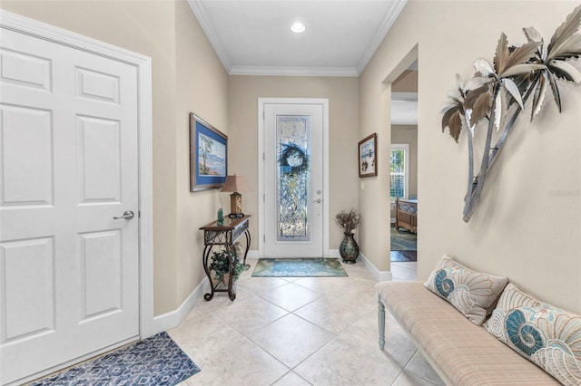 foyer featuring light tile patterned floors, baseboards, and ornamental molding