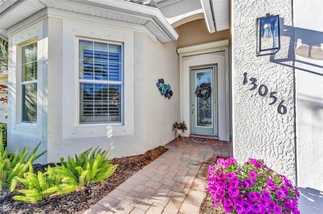 entrance to property with stucco siding