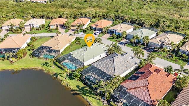 drone / aerial view featuring a residential view and a water view