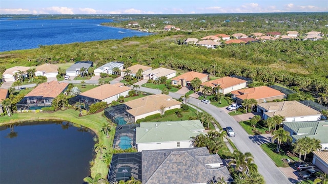 birds eye view of property with a residential view and a water view