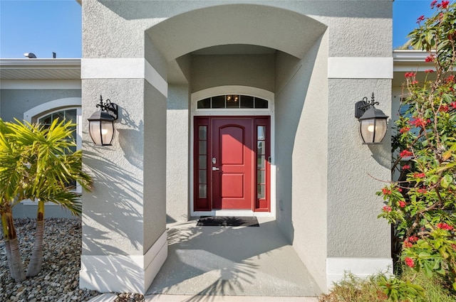 entrance to property with stucco siding