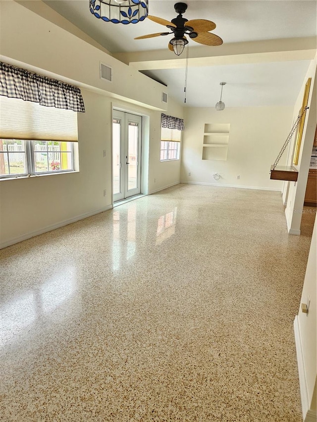 unfurnished room featuring baseboards, visible vents, french doors, and speckled floor