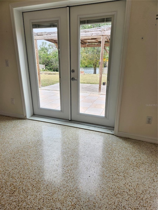 doorway to outside with baseboards, french doors, speckled floor, and a healthy amount of sunlight