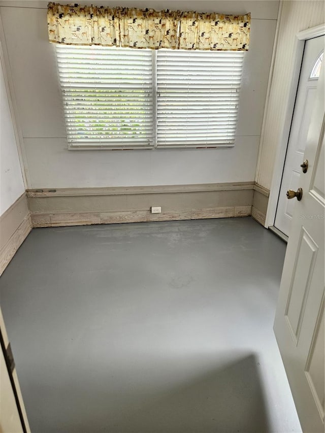 spare room featuring finished concrete floors