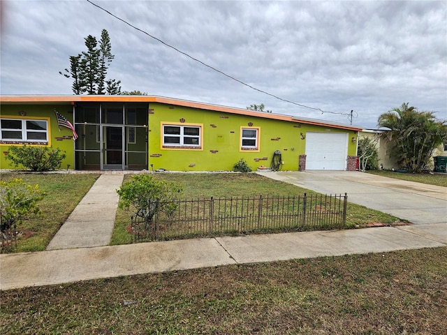 view of front facade featuring a fenced front yard, an attached garage, concrete driveway, stucco siding, and a front yard