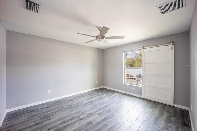 unfurnished bedroom with dark wood-style floors, baseboards, visible vents, and a ceiling fan