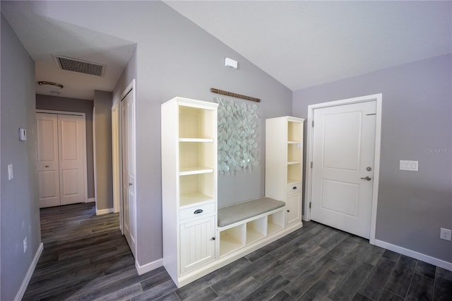 mudroom with vaulted ceiling, dark wood-style flooring, visible vents, and baseboards