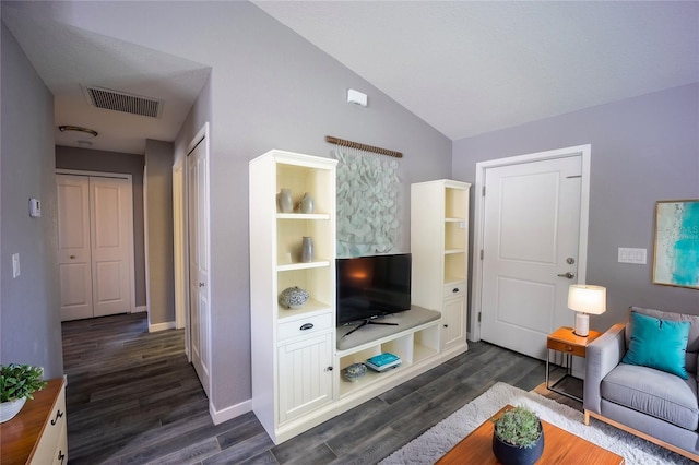 living area with lofted ceiling, dark wood-style floors, baseboards, and visible vents