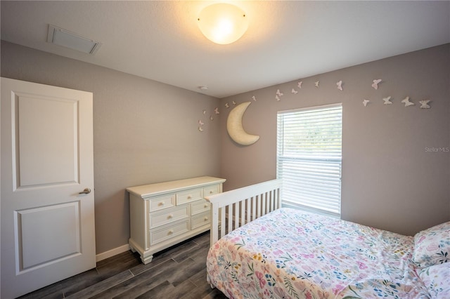 bedroom with wood tiled floor and visible vents