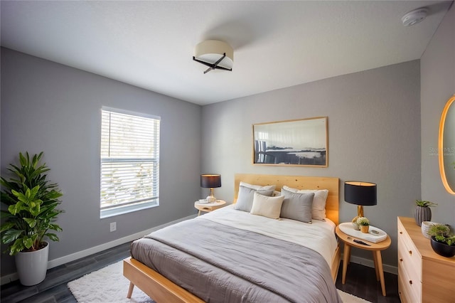 bedroom featuring wood finished floors and baseboards