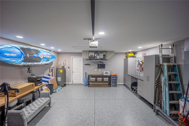 garage with recessed lighting, baseboards, a garage door opener, and electric water heater