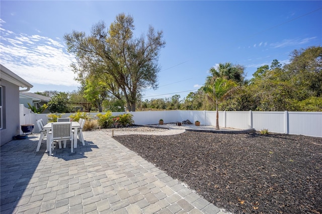 view of patio with a fenced backyard and outdoor dining area