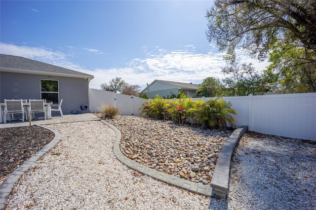 view of yard featuring a fenced backyard, a gate, and a patio