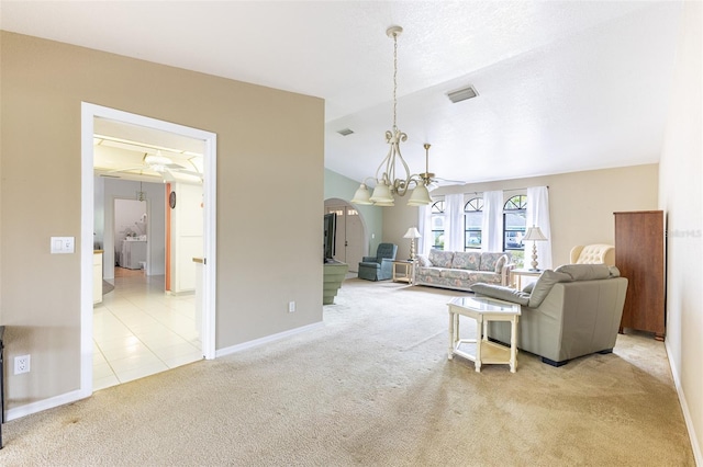 carpeted living room with arched walkways, lofted ceiling, baseboards, and an inviting chandelier