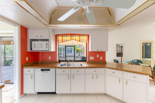 kitchen with white appliances, a healthy amount of sunlight, a sink, and ceiling fan