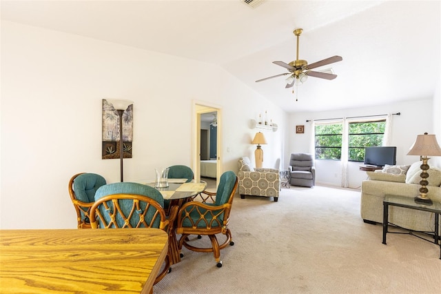 dining area featuring light carpet, ceiling fan, and lofted ceiling