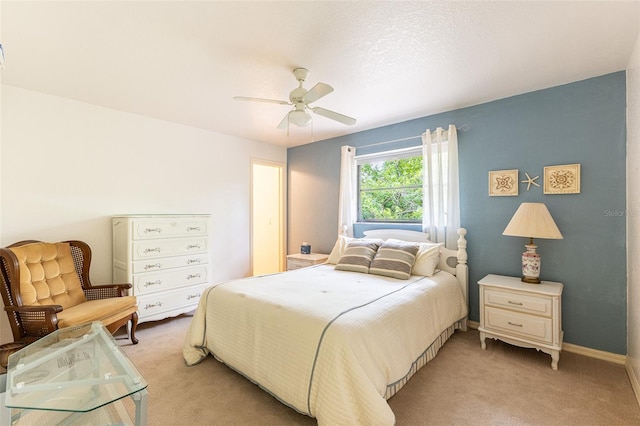 bedroom featuring ceiling fan, baseboards, and light colored carpet