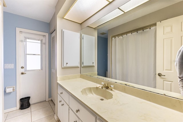 bathroom with tile patterned flooring, visible vents, baseboards, and vanity