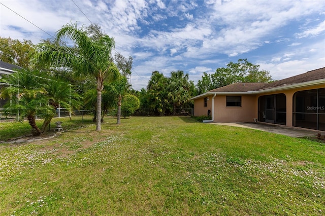 view of yard featuring fence and a patio