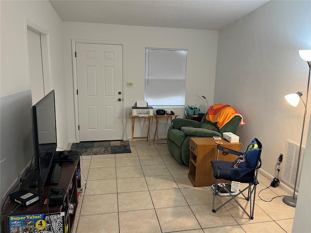 living area with light tile patterned flooring, baseboards, and visible vents