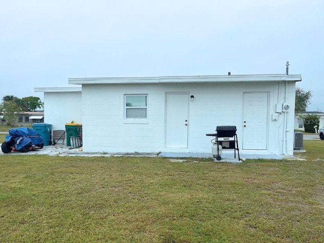 3116 Crestwood Dr, Port Charlotte, FL 33952 - rear view of property with a lawn and central AC unit