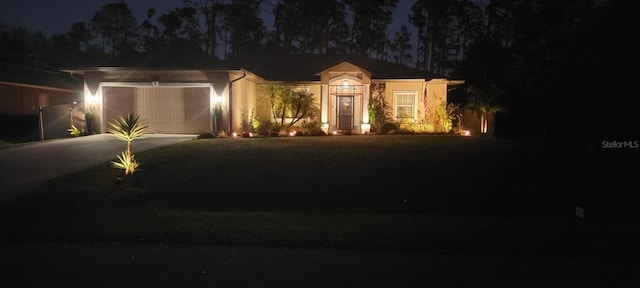 view of front facade featuring concrete driveway and an attached garage