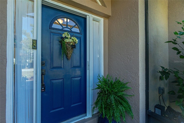 property entrance featuring stucco siding