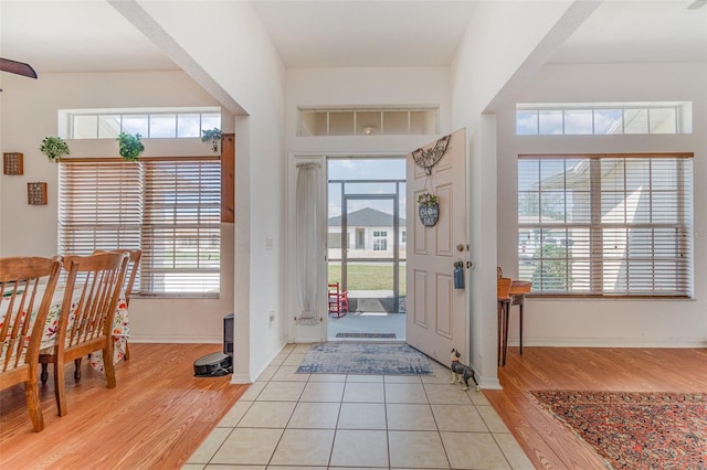 foyer featuring light wood-style floors and baseboards