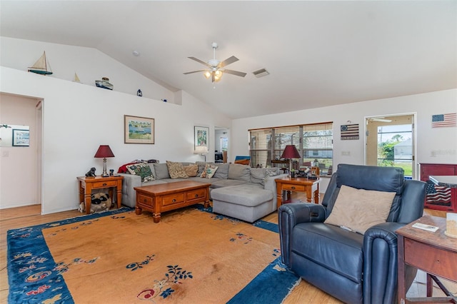 living room with a ceiling fan, visible vents, high vaulted ceiling, and light wood finished floors