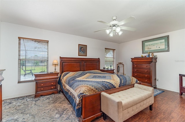 bedroom featuring ceiling fan, baseboards, and wood finished floors