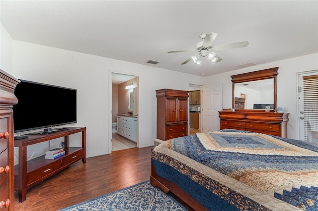 bedroom featuring baseboards, wood finished floors, visible vents, and a ceiling fan