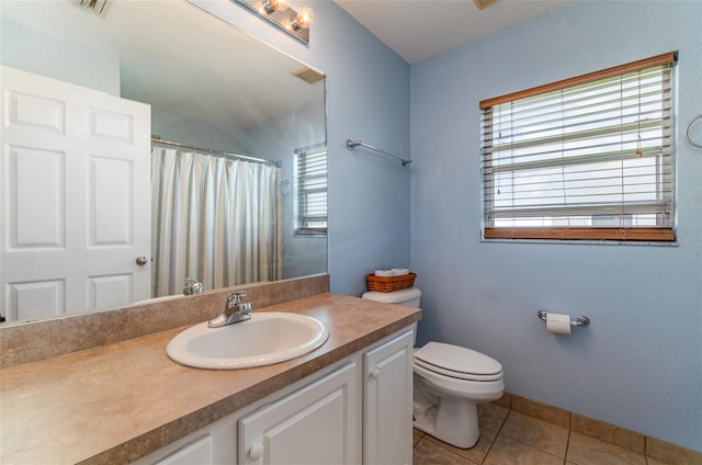 bathroom featuring vanity, a shower with shower curtain, tile patterned flooring, and toilet