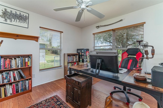 office with ceiling fan, baseboards, and wood finished floors