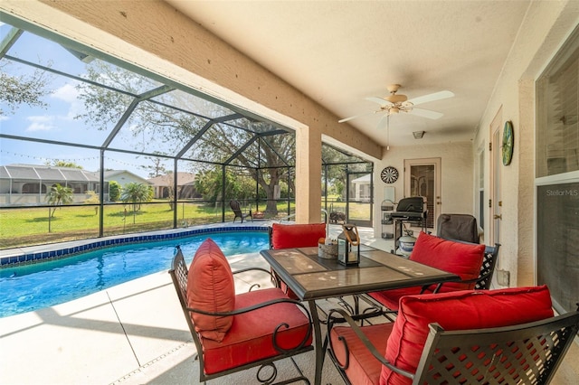 outdoor pool featuring a ceiling fan, a lanai, and a patio area