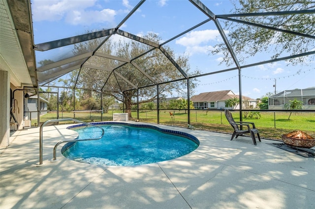 outdoor pool featuring a lanai, a patio, a fire pit, and a lawn