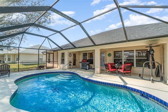 outdoor pool with a ceiling fan, a lanai, a patio, and grilling area