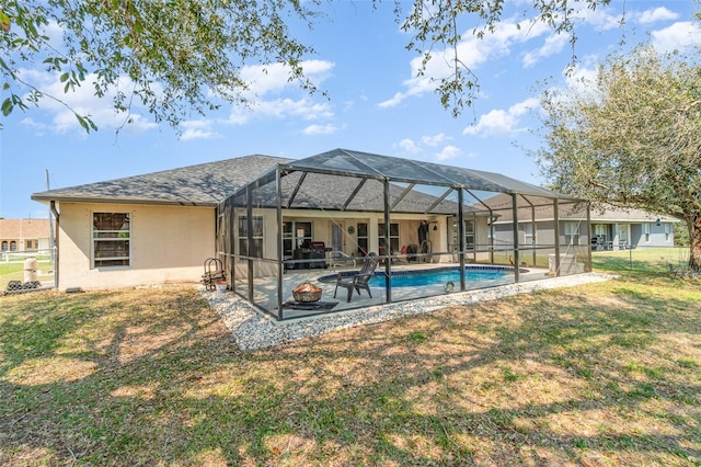 back of house with a lanai, a patio area, a lawn, and stucco siding