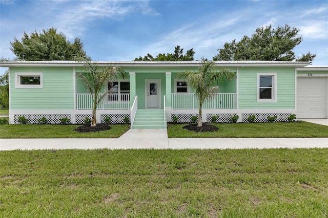 view of front of property featuring a porch, a front yard, metal roof, and a garage