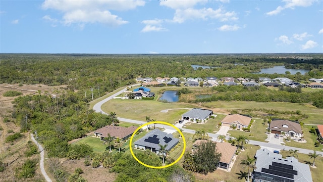 birds eye view of property with a forest view, a water view, and a residential view