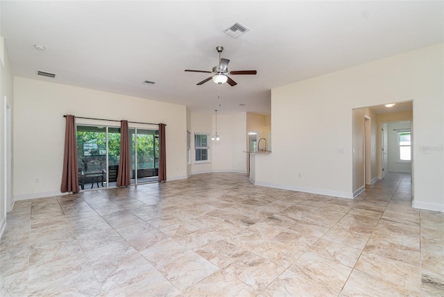 empty room with plenty of natural light, visible vents, and a ceiling fan